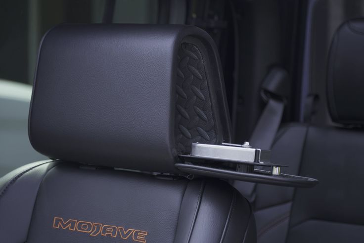 Vehicle gun safe hidden inside a truck headrest with lock mechanism visible